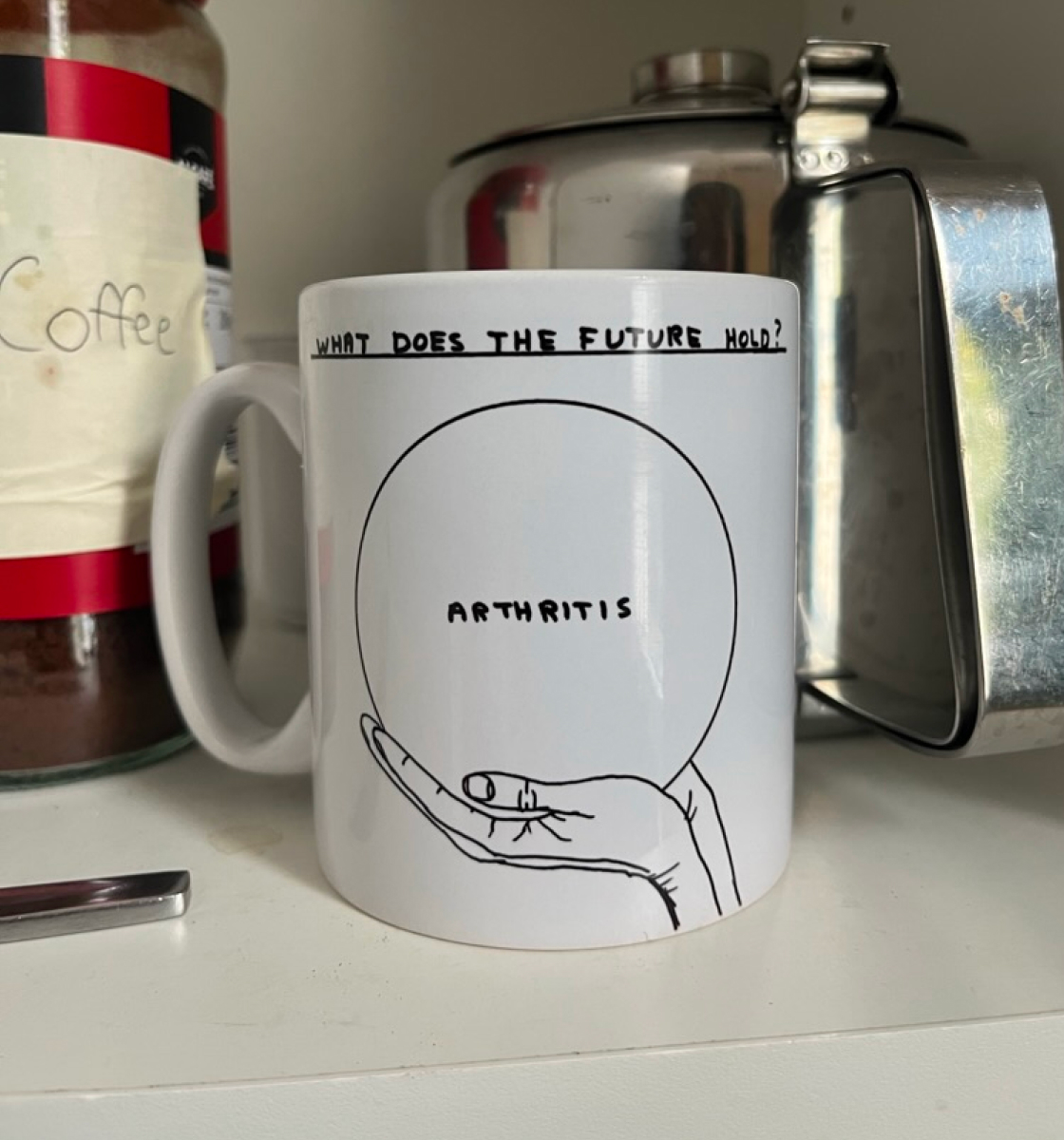 A coffee mug with the text 'What does the future hold? Arthritis'