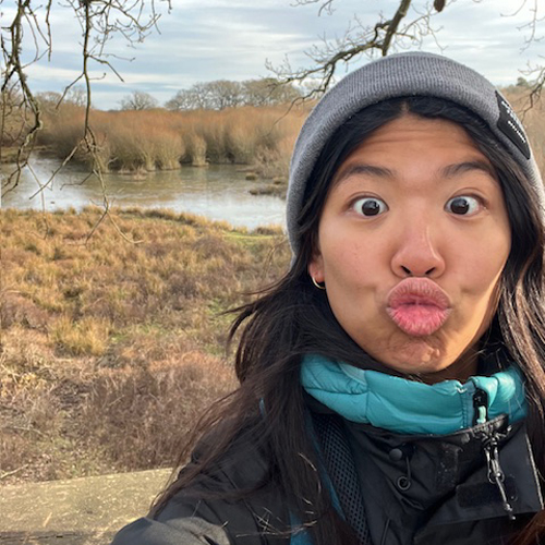 Julia with a toque infront of a lake